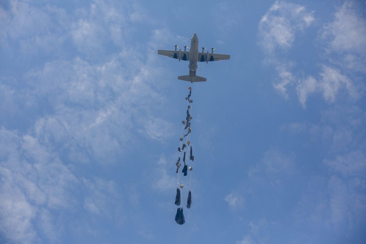 'We are not dogs': Palestinians condemn humiliation of chasing after airdropped aid in Gaza