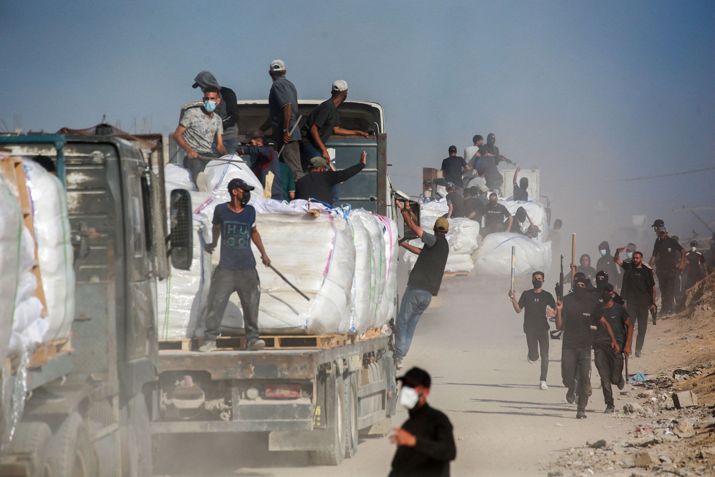 Under attack from all sides, armed clans try to protect aid coming into Gaza