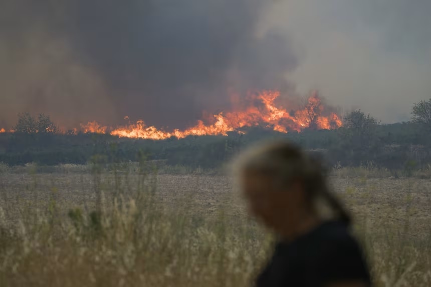 French firefighters battle to contain blaze that killed elderly woman and tore through area bigger than Paris