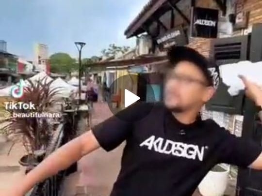 QuickCheck: Is a shop owner throwing T-shirts into the Melaka River?
