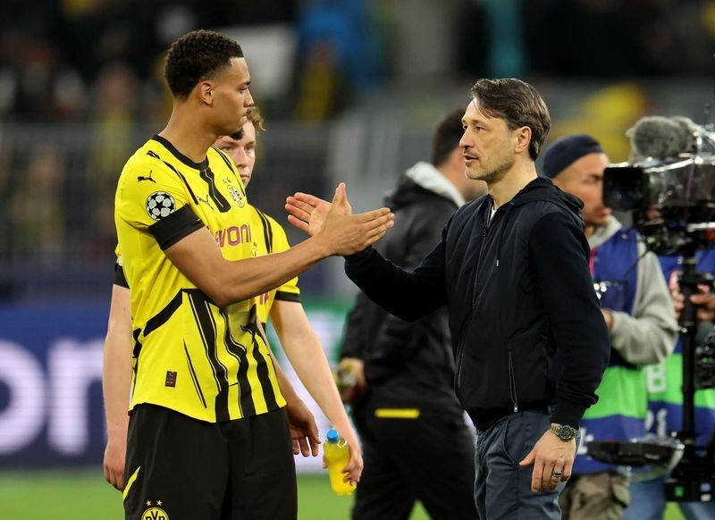 Soccer-Dortmund look to cap comeback with Champions League spot on final matchday