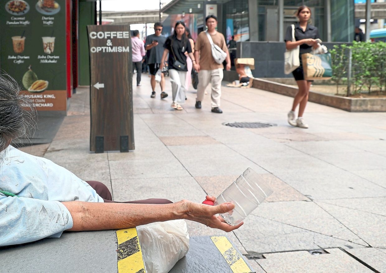 Beggars line KL's busy streets