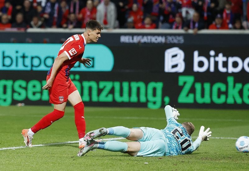 Soccer-Heidenheim battle back for 2-2 draw with Elversberg in relegation playoff