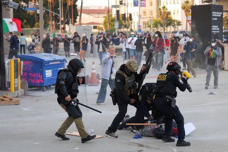 Riot police, anti-ICE protesters square off in Los Angeles after raids