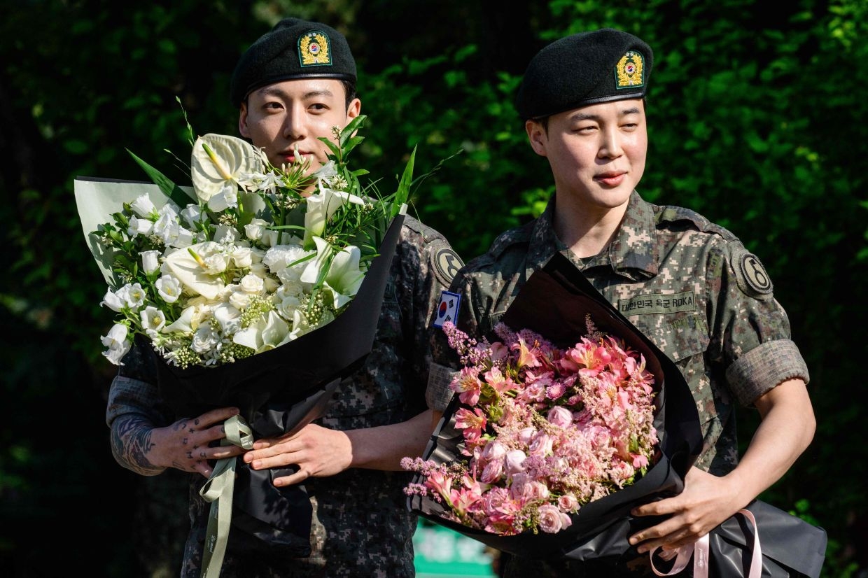 Fans greet K-pop stars Jimin and Jung Kook of BTS upon discharge from military service