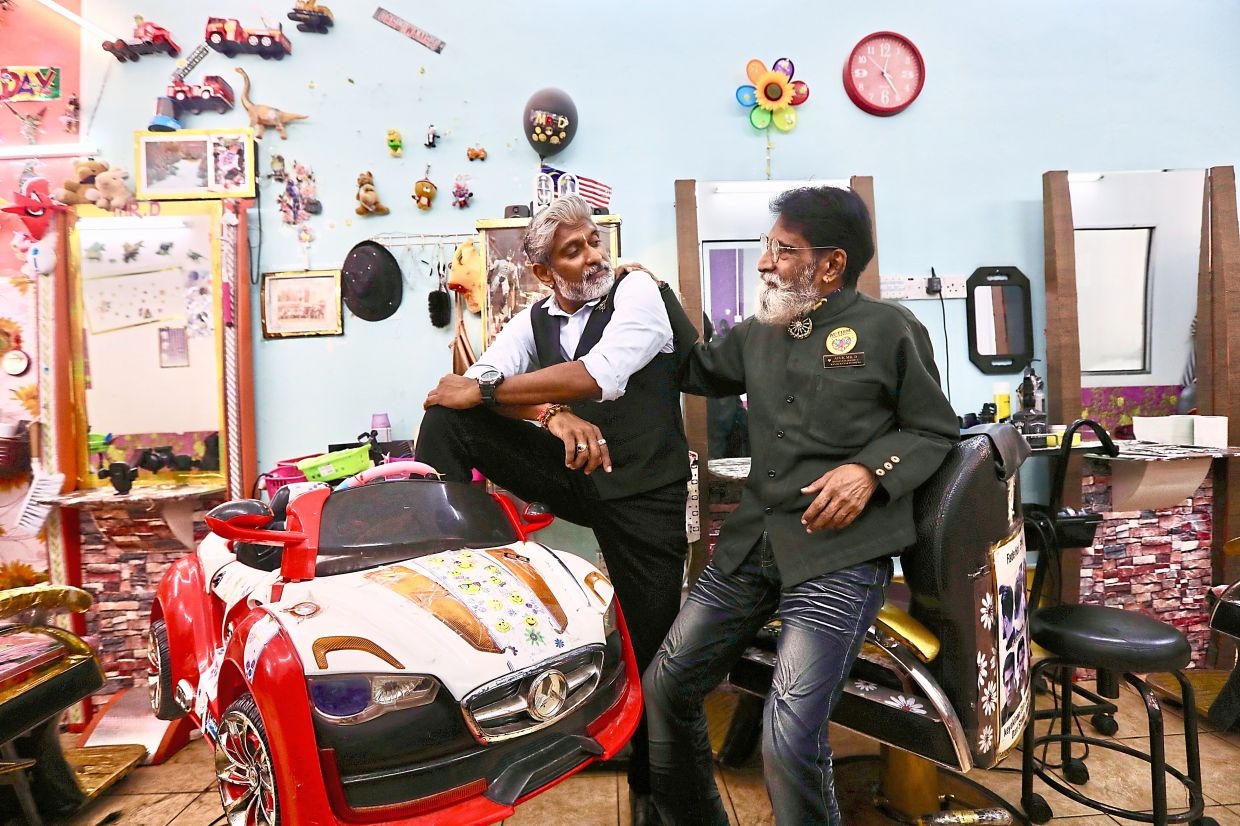 Malaysian father-son barbers have cut hair for over 1,000 kids on the spectrum