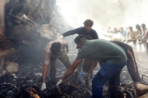 Flames and smoke in aftermath of crashed India passenger jet