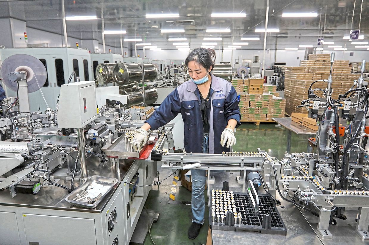 China's factory output slows, retail sales unexpectedly robust