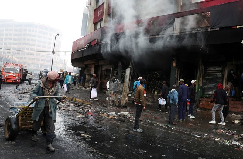 Kenyans clean up looted shops, torched buildings after day of deadly protests