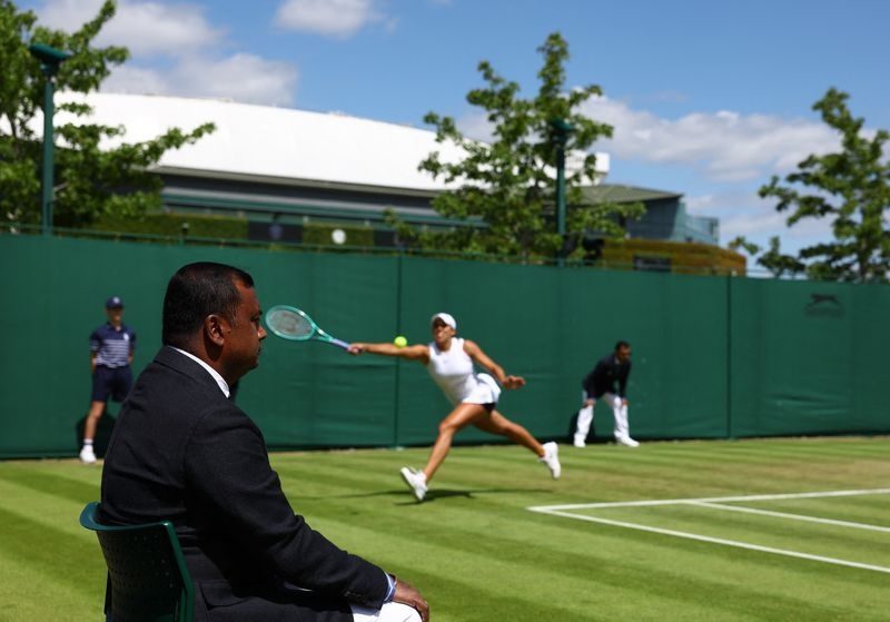 Tennis-Wimbledon's human touch yields to electronic eyes but officials embrace new role