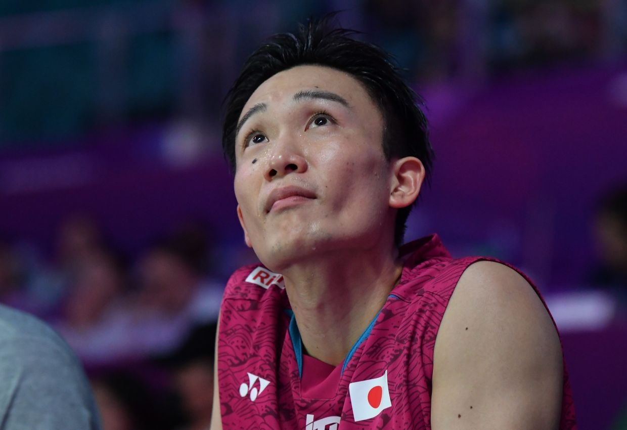 Back injury forces Momota out of Lin Dan Cup