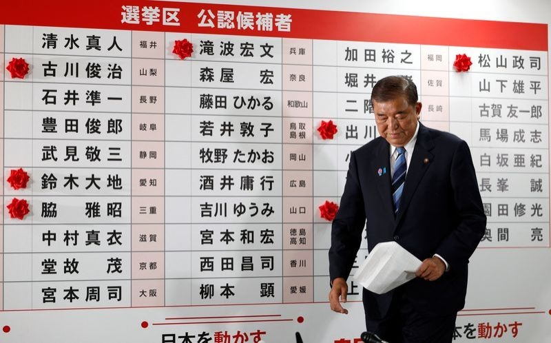Japan PM vows to stay on after bruising election defeat
