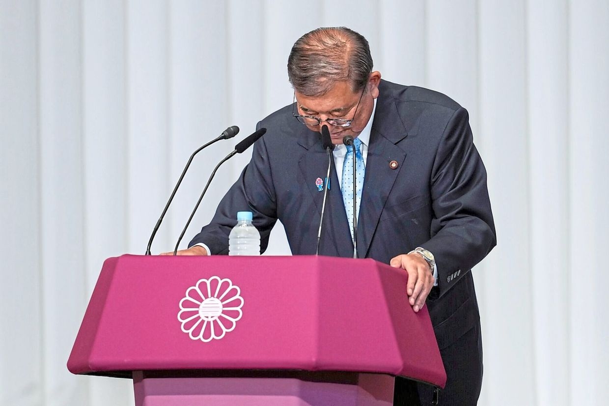 PM hangs on after election debacle