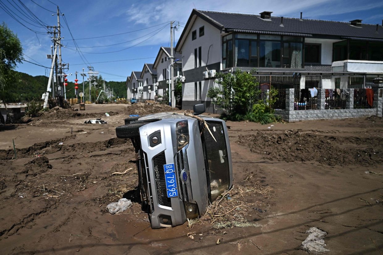 Monsoon peaks in south China, unleashing landslides and a surge in virus cases