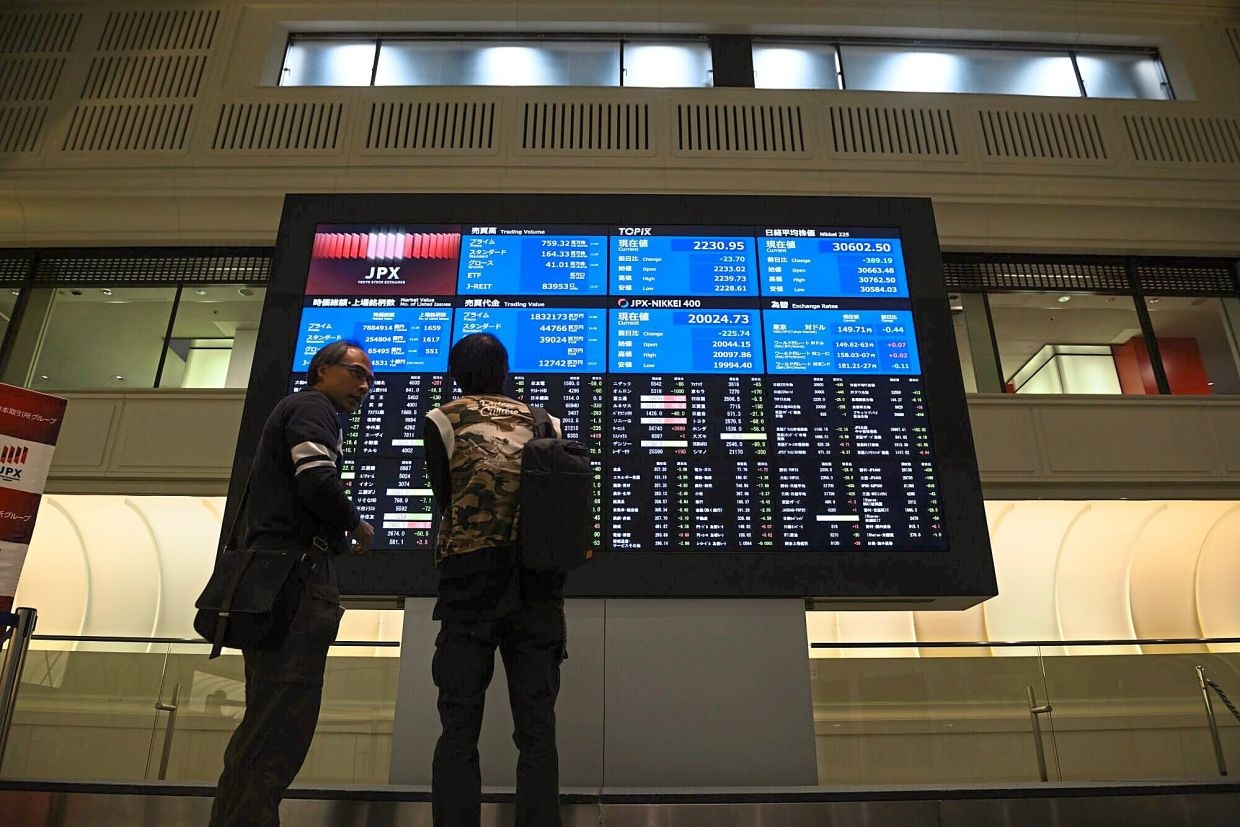 Japan index hits record high on earnings boost, other Asian markets ease