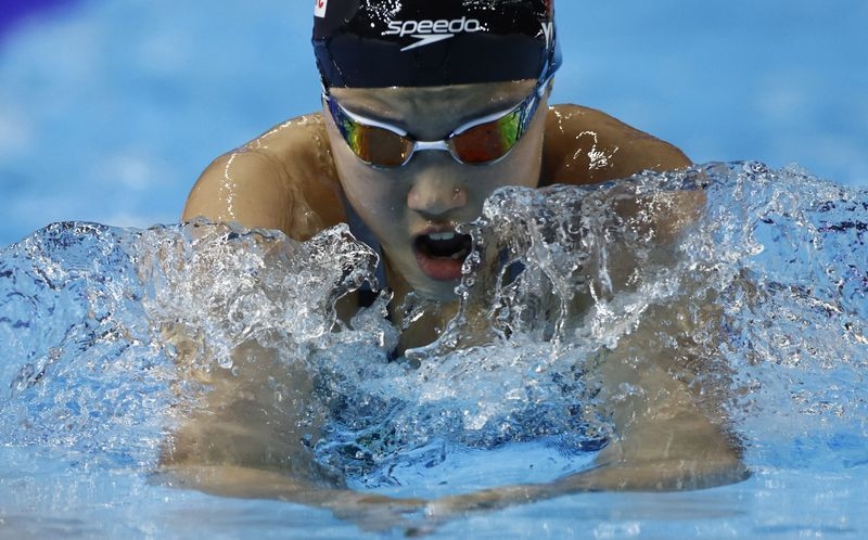 Swimming-The time of her life; Davies thrilled by 12-year-old's medal feat