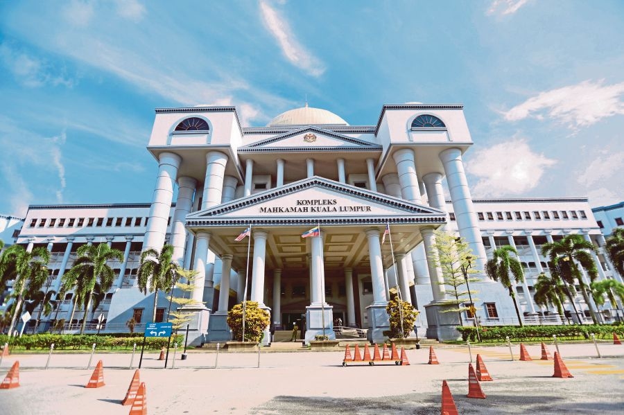 Assistant to company director charged with cheating over RM5.1 million glove deal