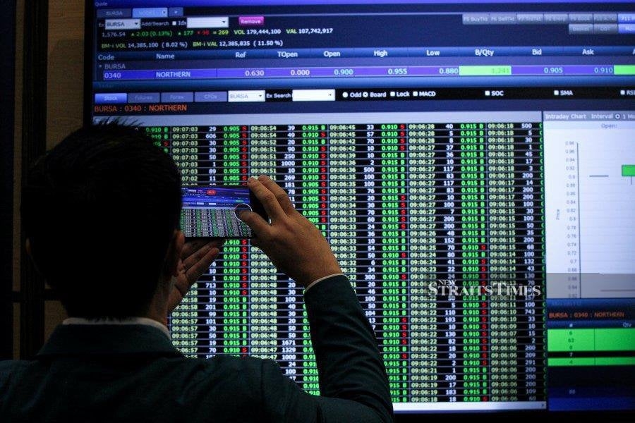 Bursa Malaysia almost flat at midday