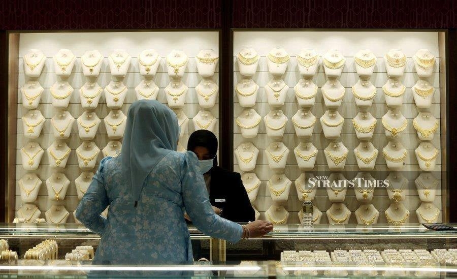 Gold steady as investors await US trade talk updates, ECB decision