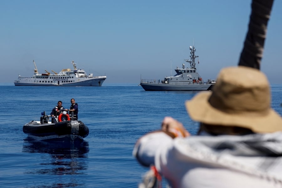 Flotilla negotiates docking as Gaza-bound aid ship remains stranded after drone attack