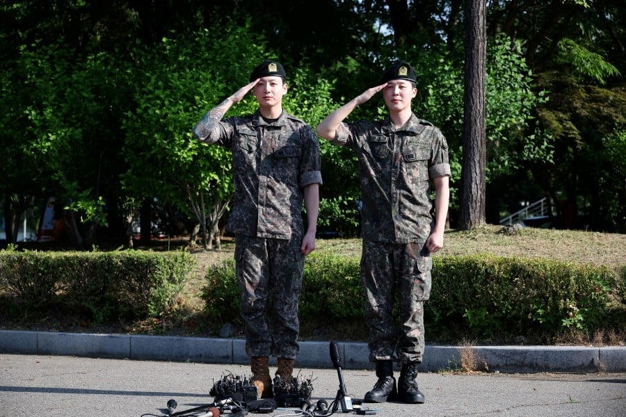 Tears, tattoos, Cartier watches: fan frenzy at BTS army discharge