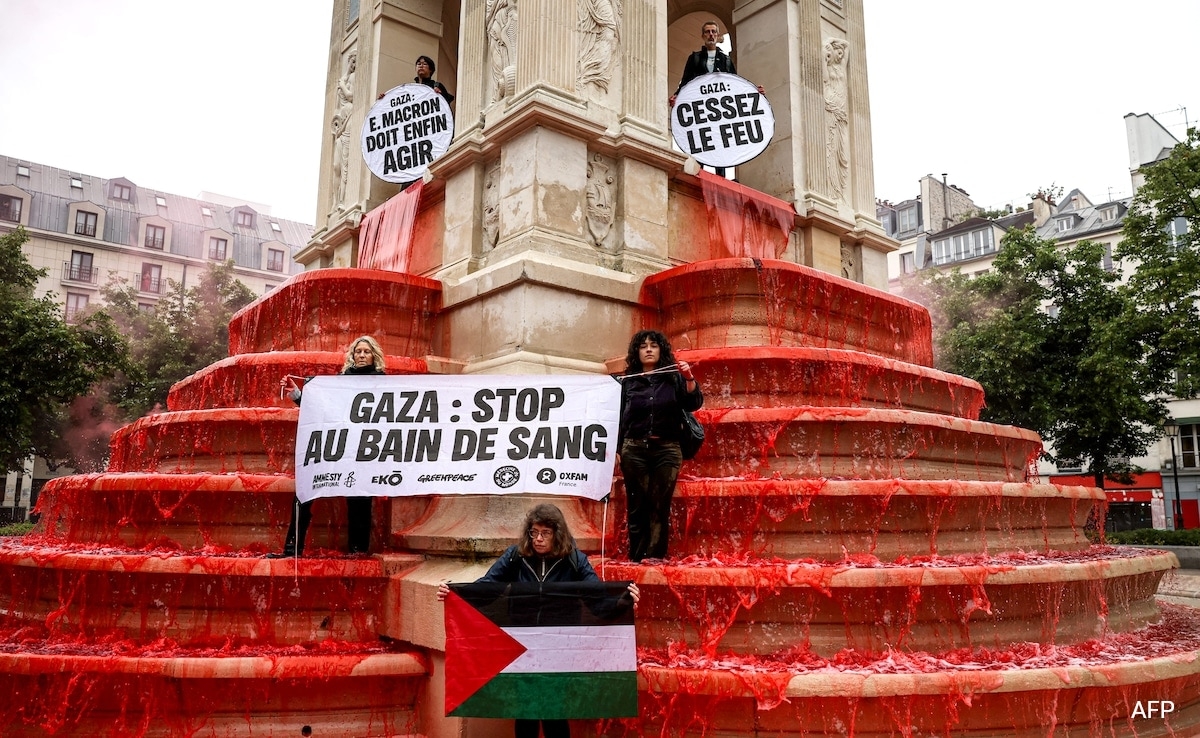 Activists Turn Paris Fountain Red To Denounce Gaza "Bloodbath"