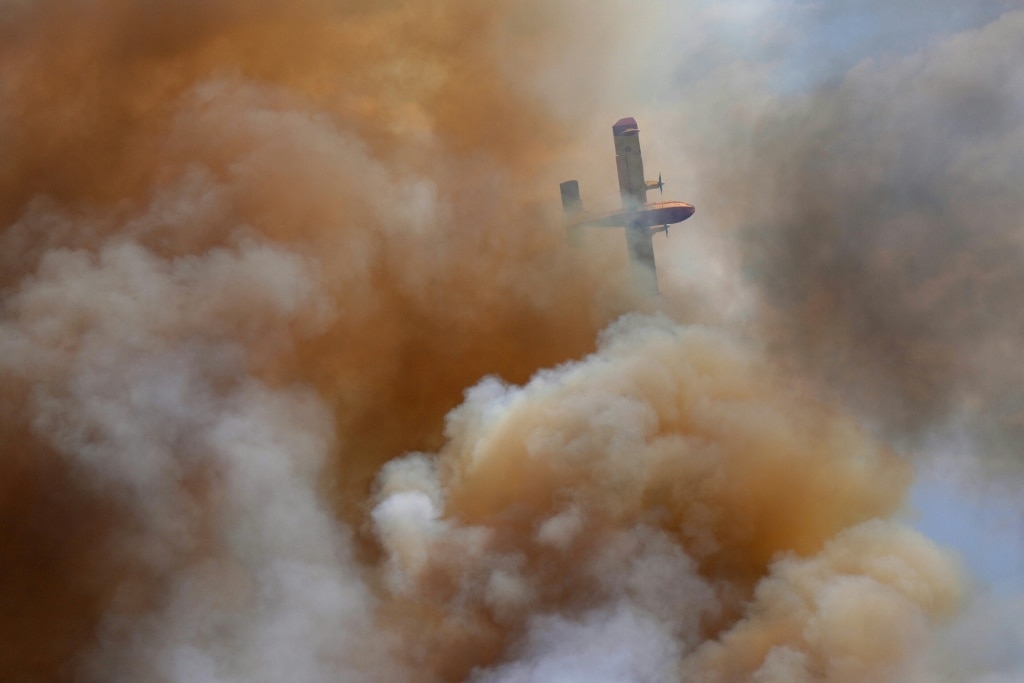Spain suffers third wildfire death, Greece beats back flames