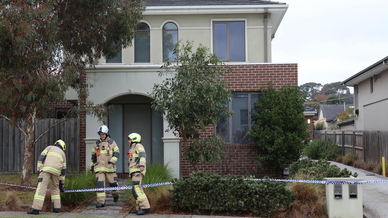 A woman has been charged after a house fire critically injured two young girls