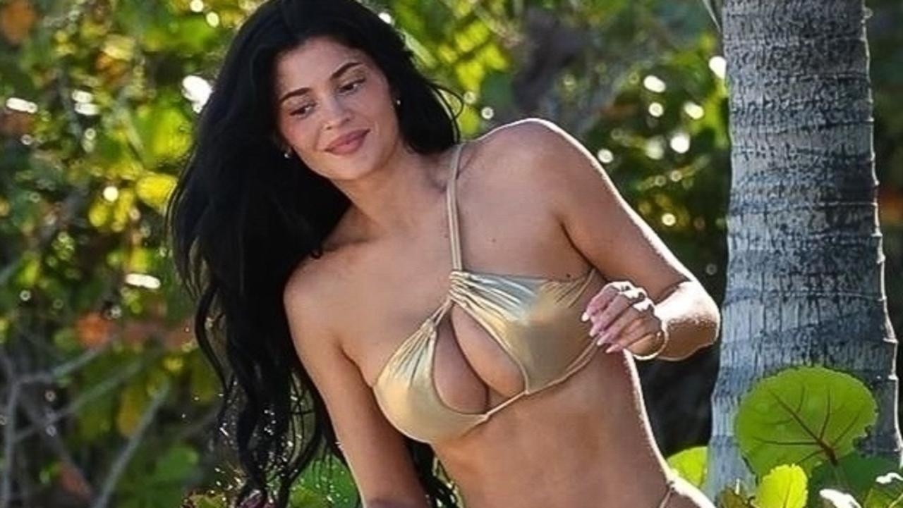 Kylie Jenner shows off her figure in a revealing gold bikini
