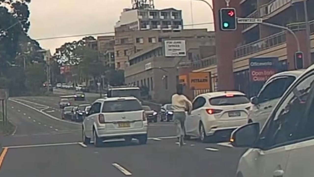 Heart-stopping moment unconscious driver rolls through a busy Sydney intersection