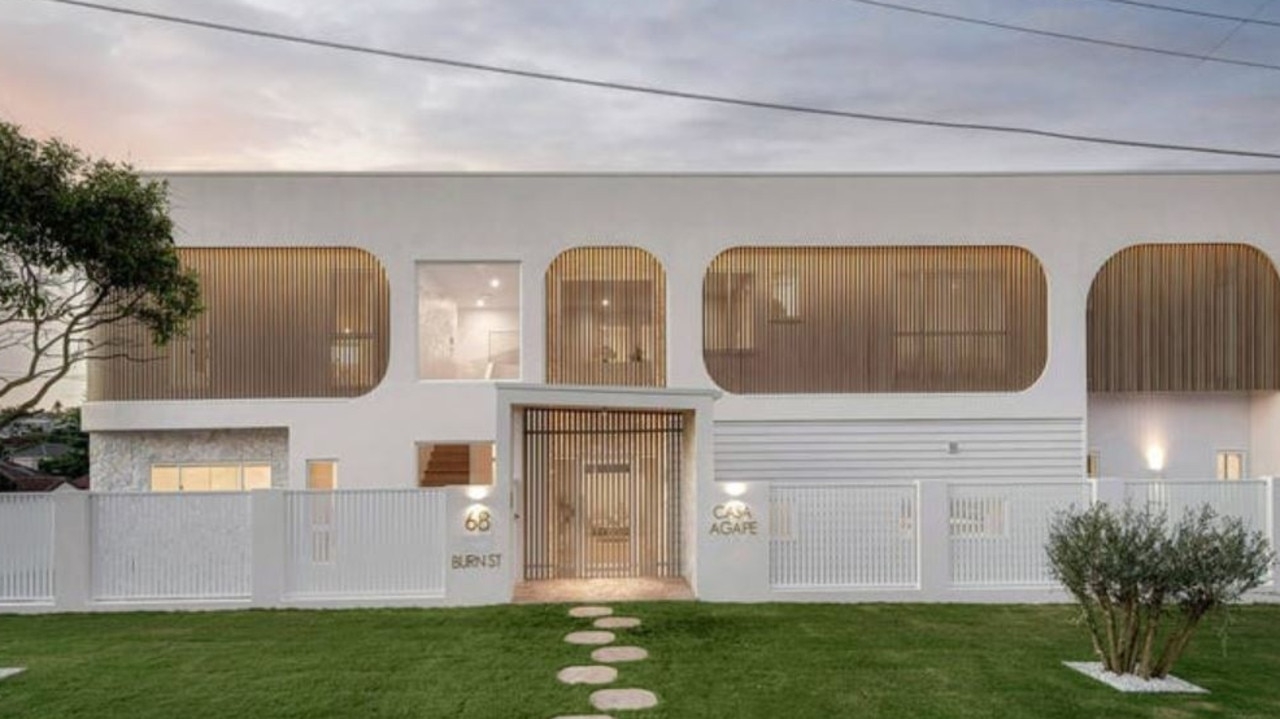 Huge suburban crowd cheers for luxury house sale at sausage sizzle auction