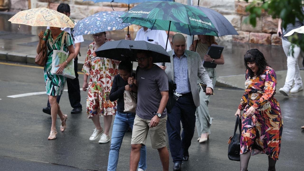 Two women taken to hospital after being injured in separate lightning strikes as deluge of rain hammers southeast Queensland