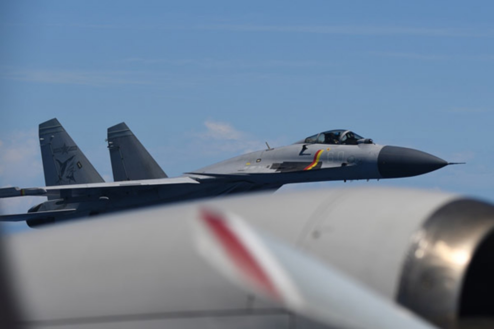 Pictures Show Chinese Jet Buzzing US Ally From Aircraft Carrier