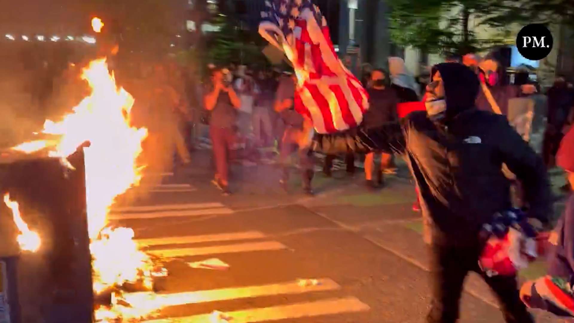 Watch: Man Saves US Flag From Angry Anti-ICE Mob Trying to Burn it