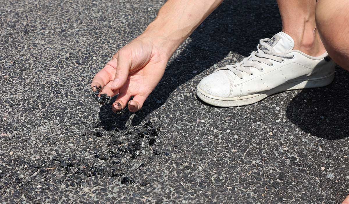 Woman narrowly avoids being hit by car after flipflop sticks to 'molten tarmac'