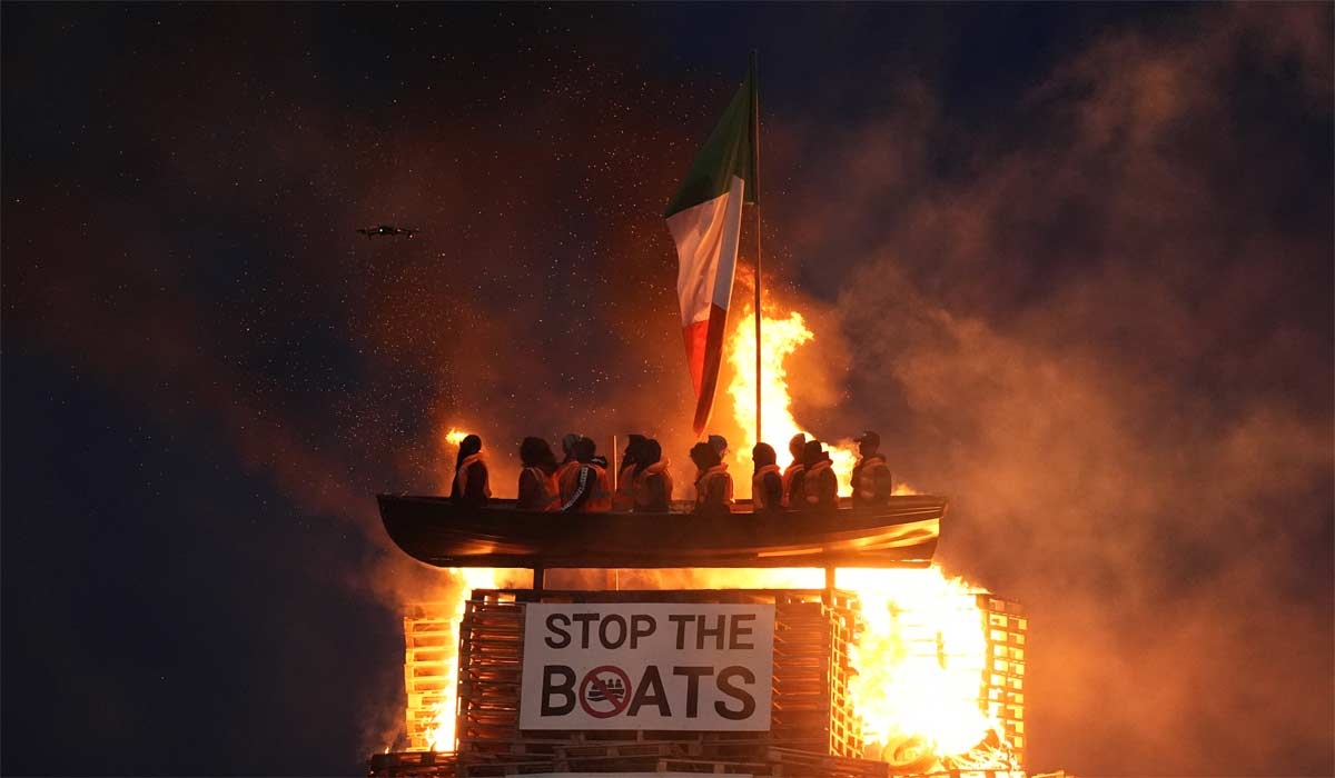 Tyrone bonfire with 'hateful' migrant boat effigy on top set alight