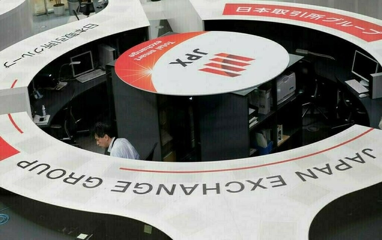 Nikkei ends at record high as yen weakens