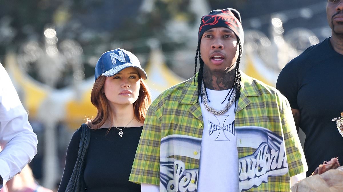 Tyga looks in high spirits with his new girlfriend Madelaine Petsch as they enjoy a day out at Disneyland