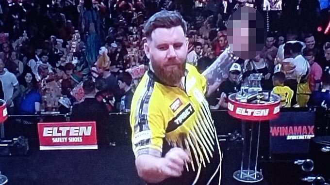 Shocking moment darts star holds up a middle finger at crowd in Germany after fan abuse