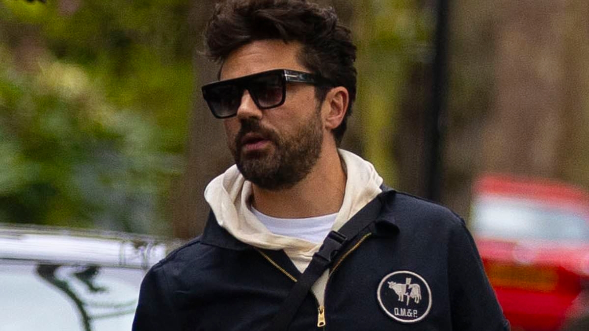 Dominic Cooper flashes his Calvin Kleins as he cleans out his Range Rover and classic red Austin Healey-Sprite in London
