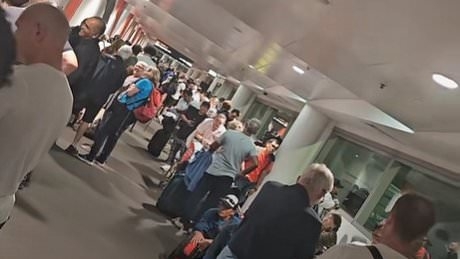 Chaos as huge crowd forms at Brisbane airport after massive mistake leads to passengers being rescreened over security concerns