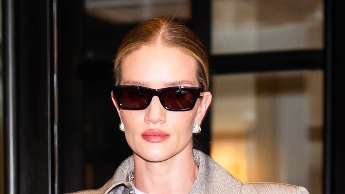 Rosie Huntington-Whiteley, 38, is the epitome of chic in a grey trench coat as she steps out in New York City