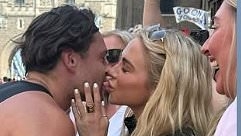 Gabby Allen kisses boyfriend Casey O'Gorman from the crowds as he runs the London Marathon - after finally making their relationship official