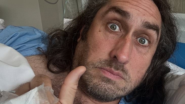 Comedian Ross Noble forced to reschedule 'next few shows' due to a kidney infection as he shares snap from hospital bed