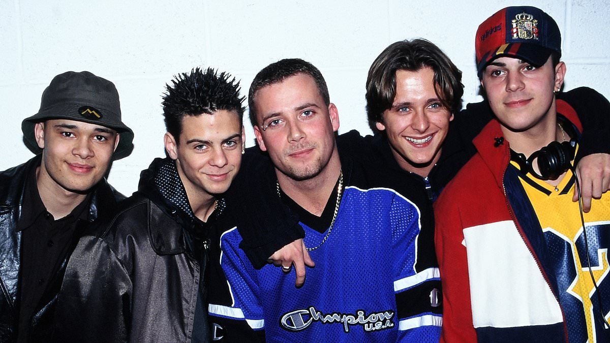 Five star admits he feels 'much cooler' being in the band now as group poke fun at their wild 'extra baggy' stage outfits during magazine cover shoot