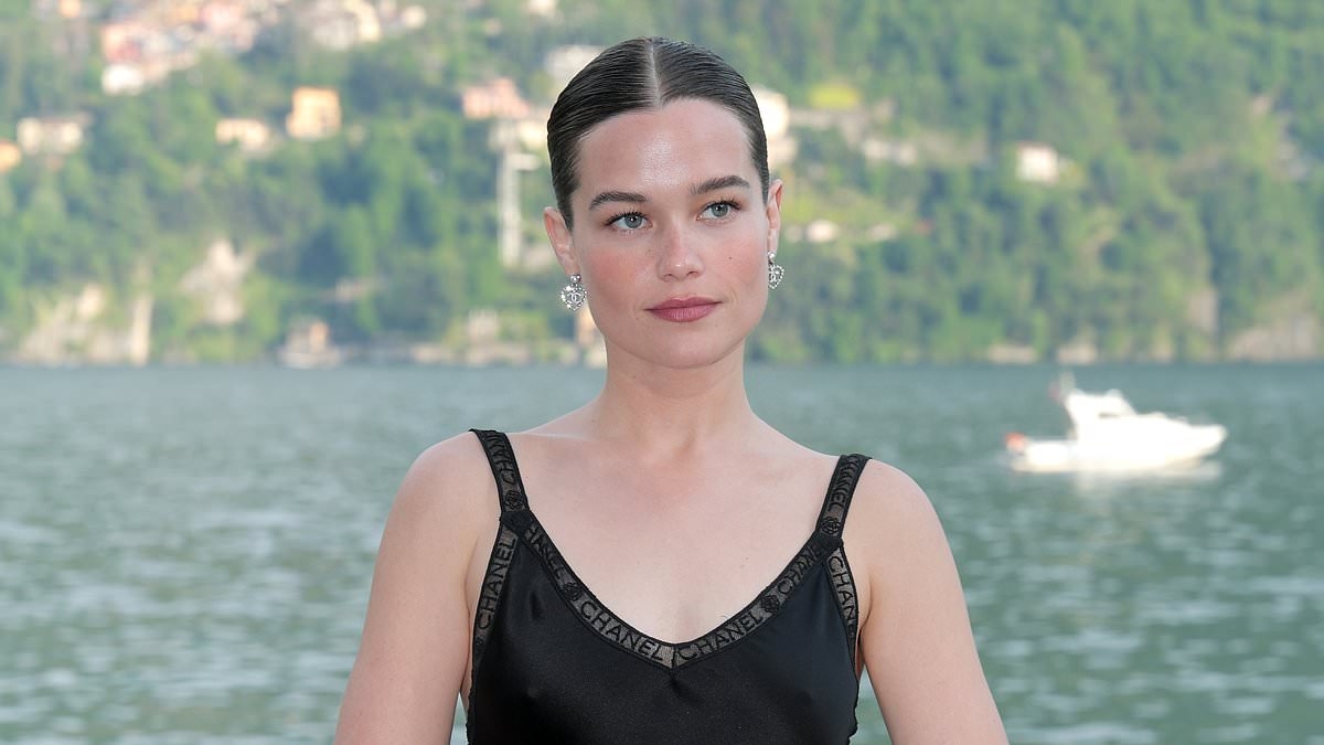 White Lotus star Sarah Catherine Hook looks elegant in a black satin dress as she joins chic Margaret Qualley and Lupita Nyong'o at Chanel Cruise fashion show on Lake Como