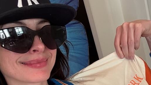 Hollywood star Anne Hathaway appears in high spirits as she poses in Arsenal shirt ahead of her beloved team's match against PSG