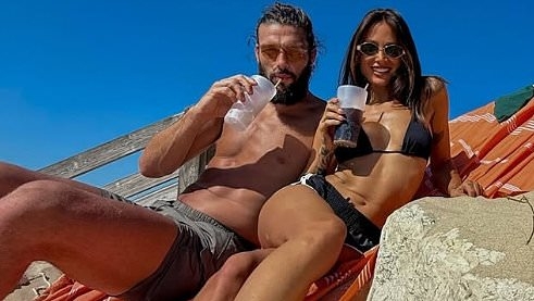 Lou Teasdale and Andy Carroll look smitten as they soak up the sun on holiday amid married footballer's 'plans to propose'