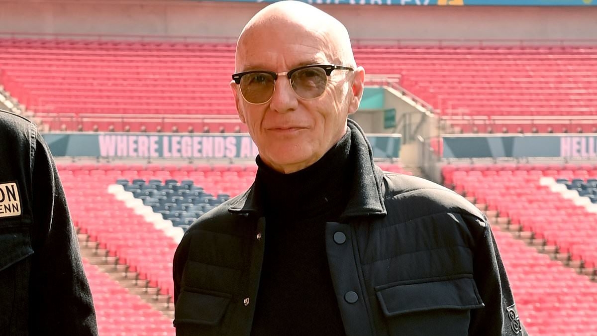 80s pop icon looks unrecognisable as he's pictured at Wembley stadium - but can you guess who it is?