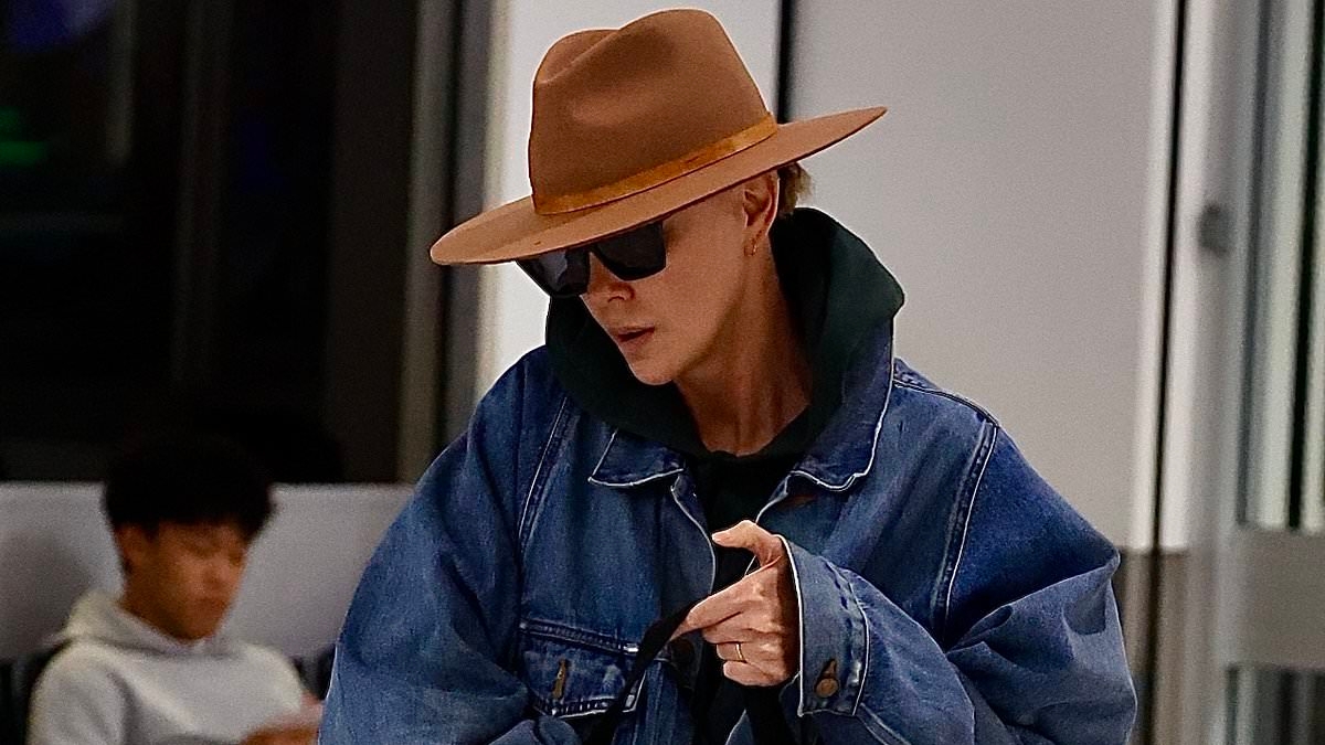 Hollywood A-lister goes incognito in dark sunglasses and fedora as she jets out of Sydney